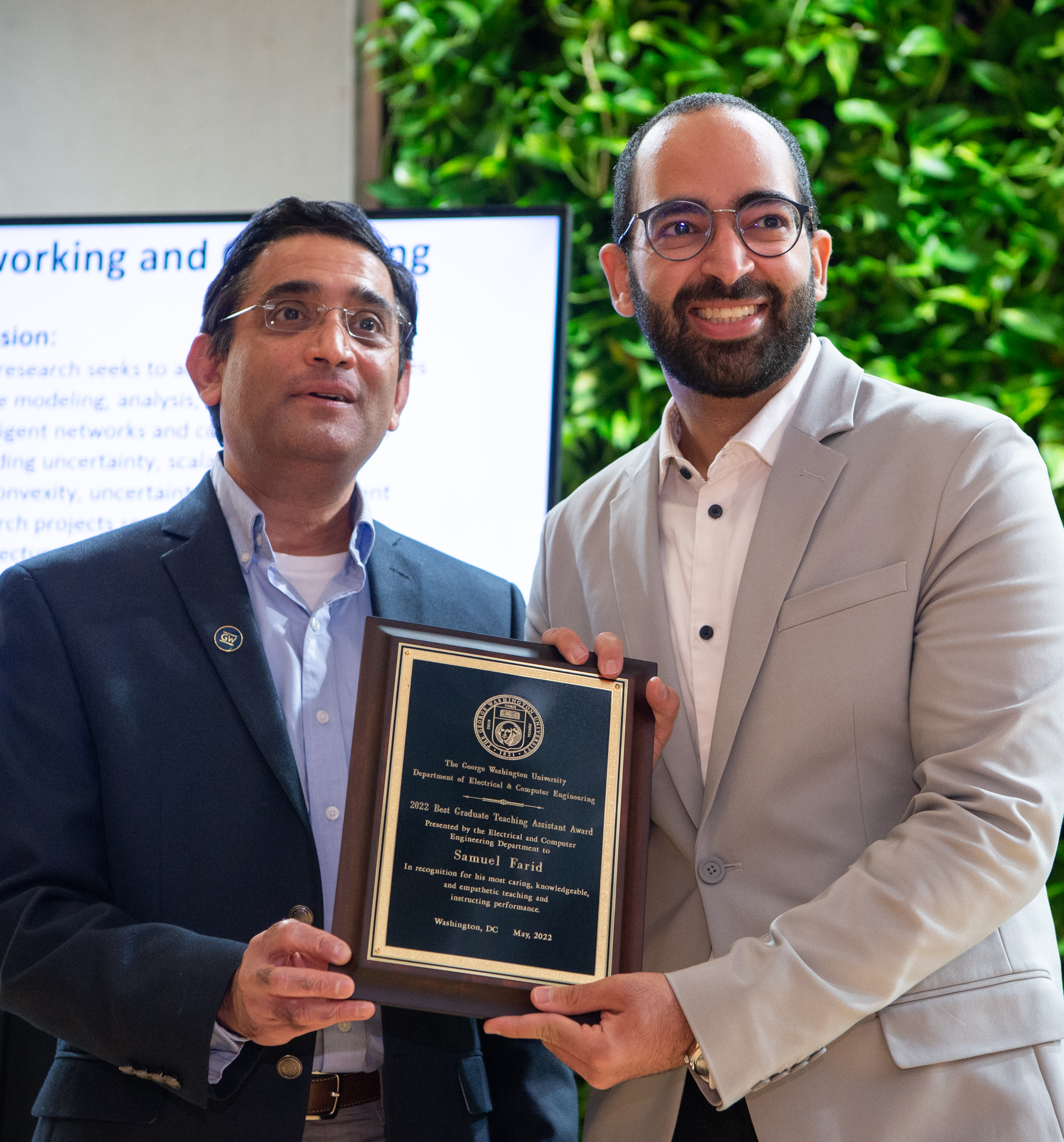 Samuel Farid accepting award from Dr. Subramaniam