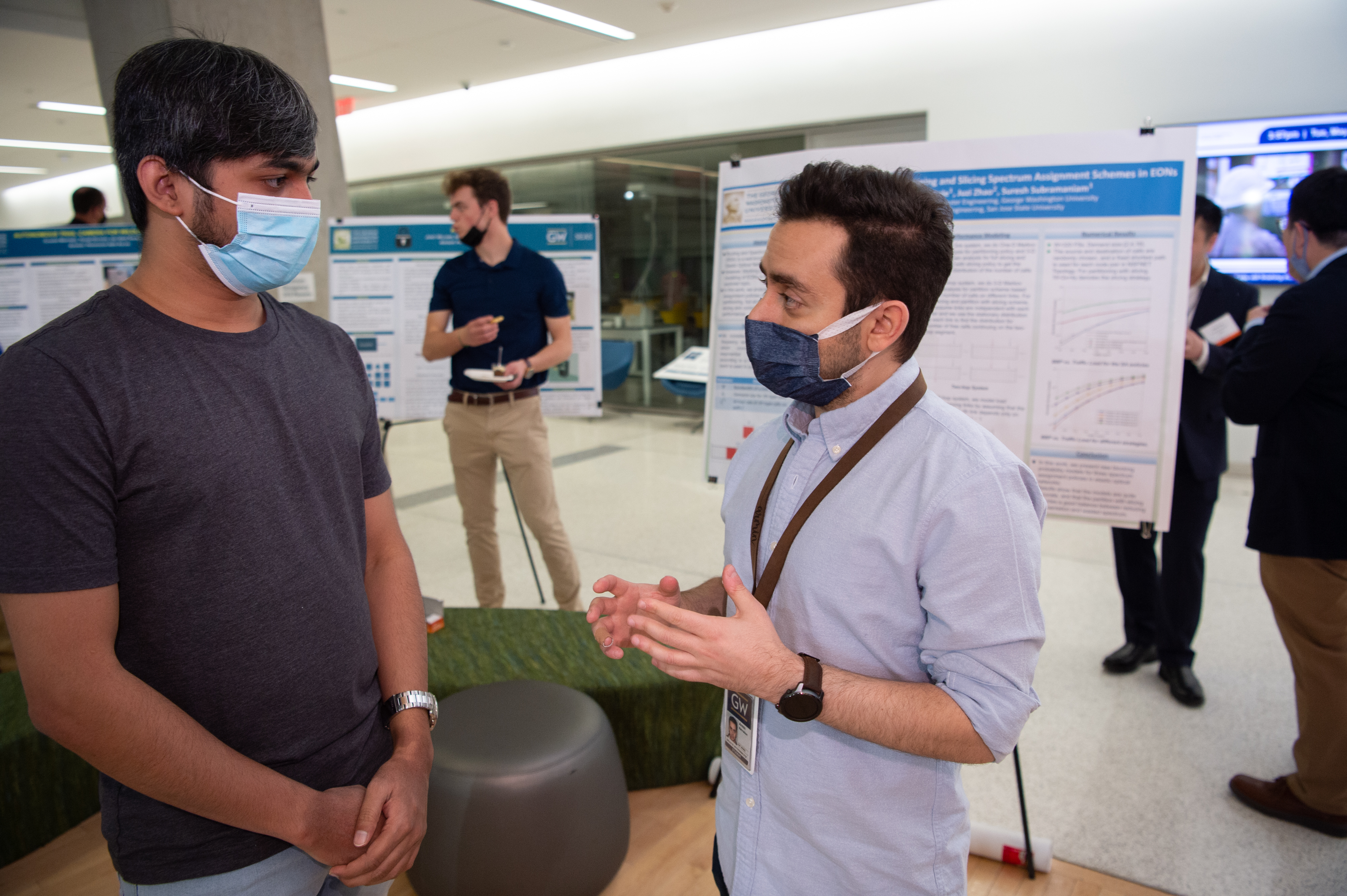 students speaking at poster showcase