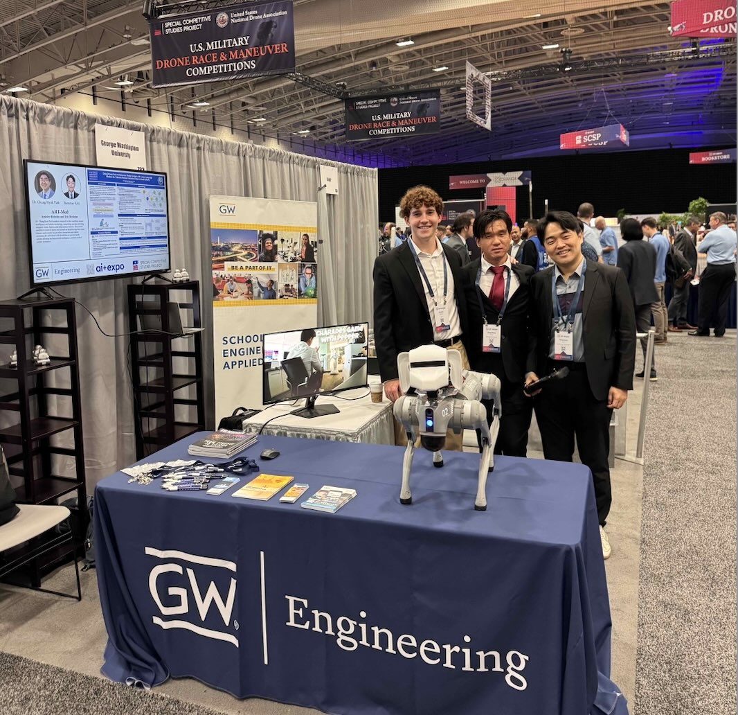 Aidan Schurr with classmates at GW Engineering's table