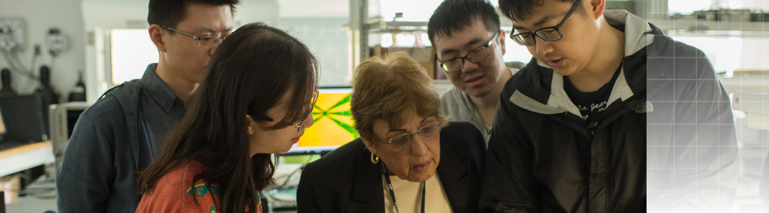 students and professor working in lab