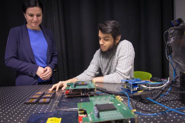 Adam and Yousuf looking at the experimental set-up