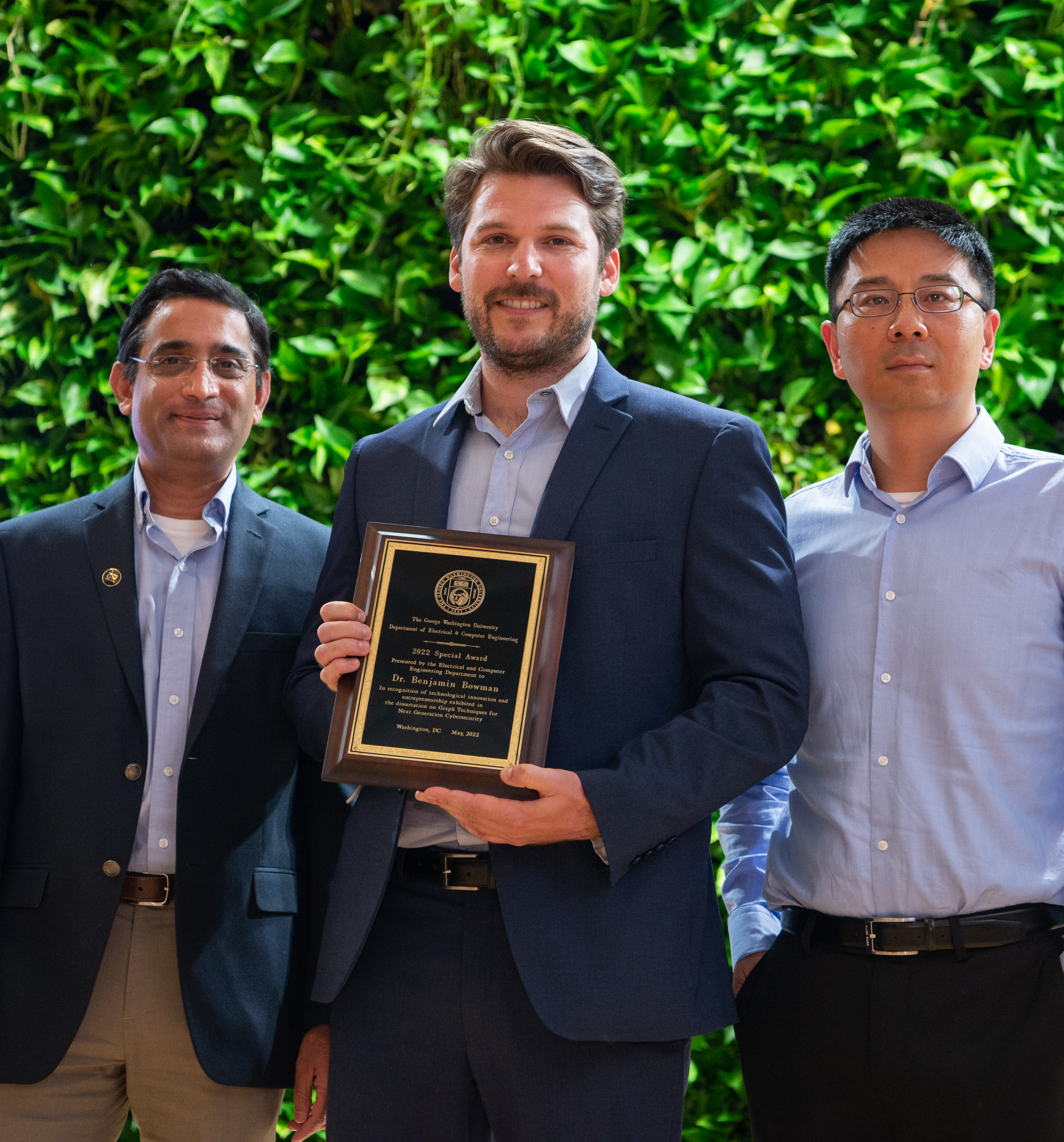 Dr. Benjamin Bowman accepting award standing with Dr. Subramaniam and Dr. Huang