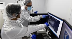 Professor Gina adam and researcher in lab
